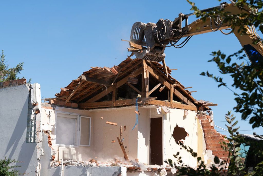 excavator in demolition of home residential building in Geelong